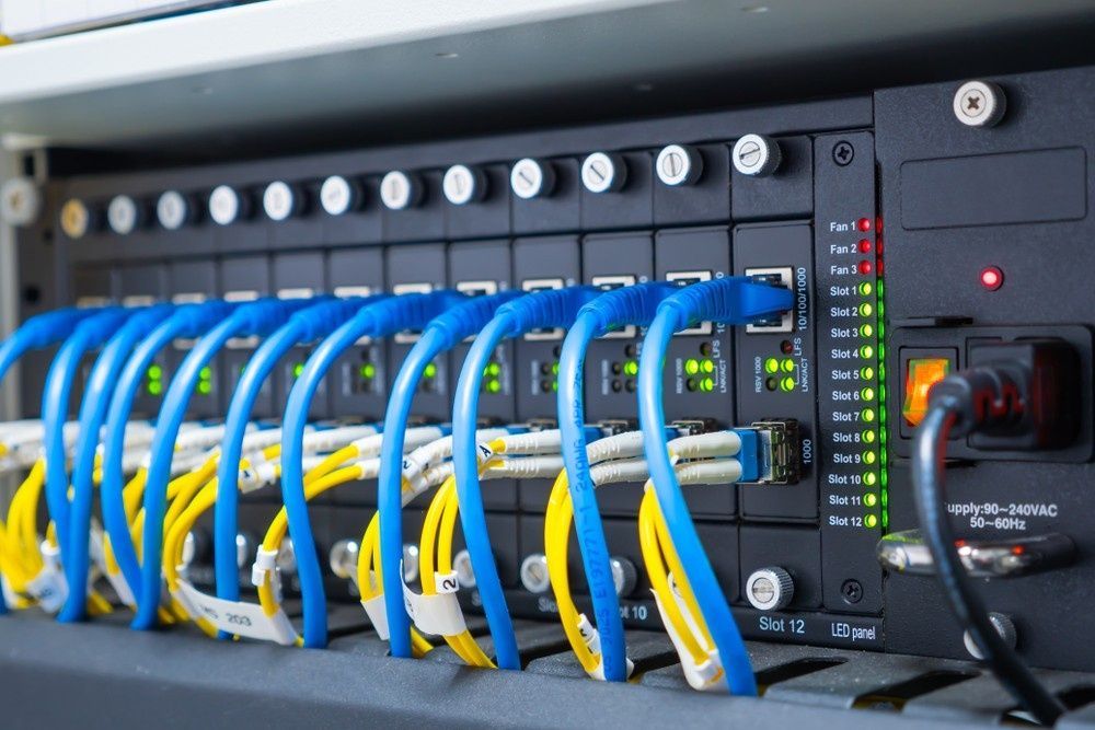 Network Server With Blue and Yellow Ethernet Cables — Robert Coony Electrician in Nambucca Heads, NSW