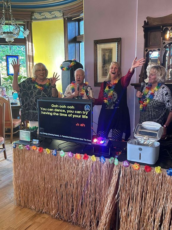 A group of people are standing around a table in a room.