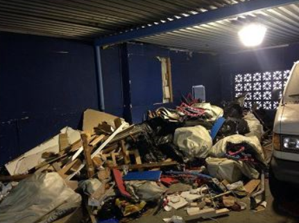 Before photo of junk inside a garage