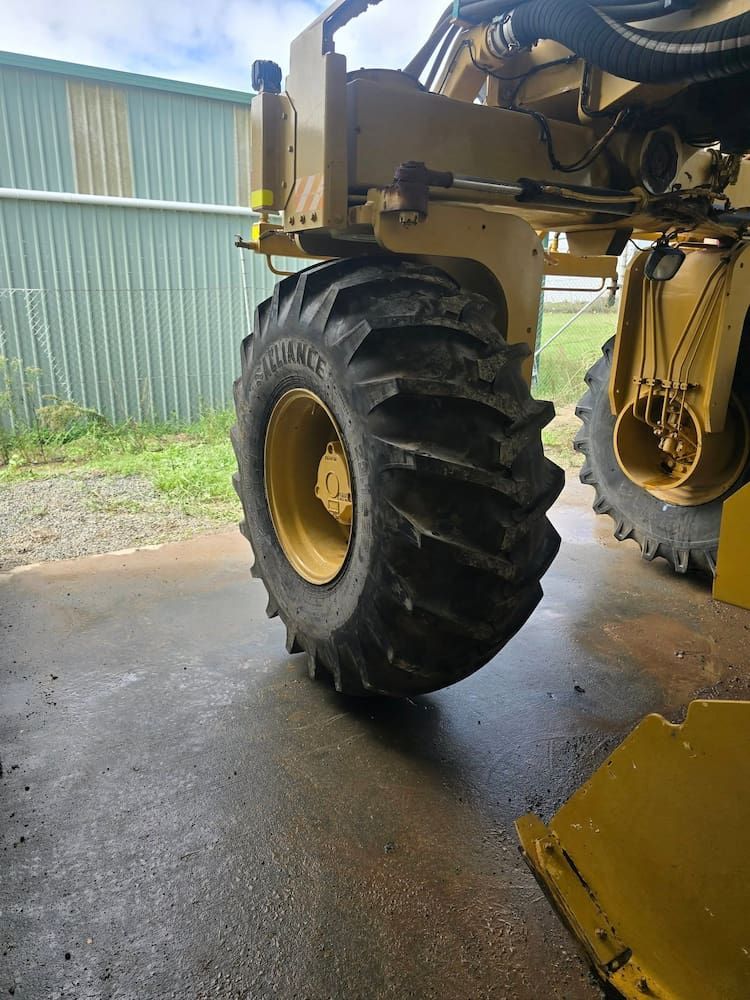 A Large Tire is on the Back of a Yellow Tractor — Peel Valley Tyres in Taminda, NSW