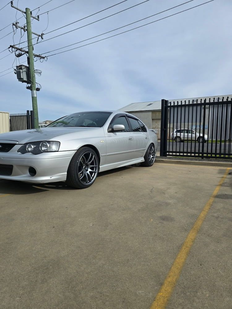 A Silver Car is Parked in a Parking Lot Next to a Fence — Peel Valley Tyres in Barraba, NSW