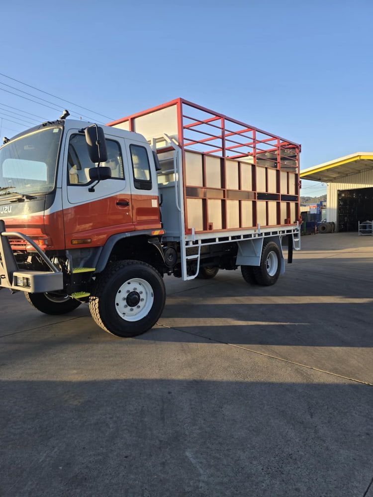 A Red and White Truck is Parked in a Parking Lot — Peel Valley Tyres in Gunnedah, NSW