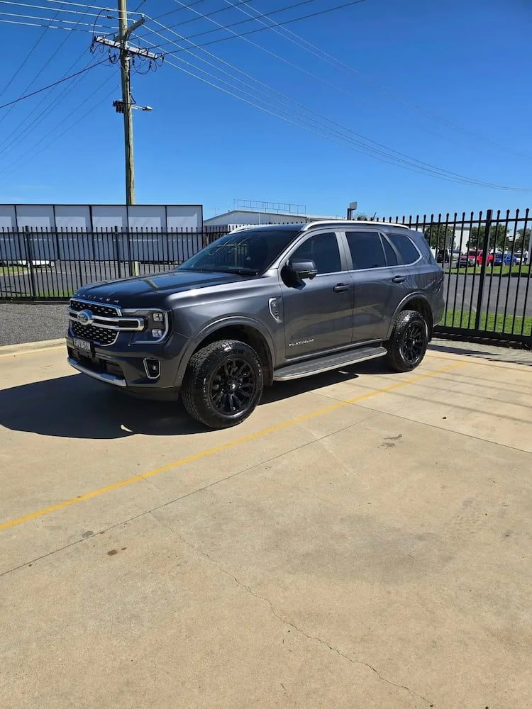 A Gray Suv is Parked in a Parking Lot Next to a Fence — Peel Valley Tyres in Murrurundi, NSW