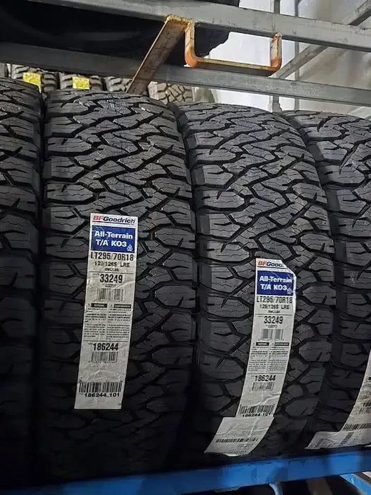 Tires stacked on a shelf, with visible tread and labels, in a store. — Peel Valley Tyres in Barraba, NSW