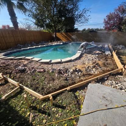 Pool under construction; wooden forms frame the perimeter.