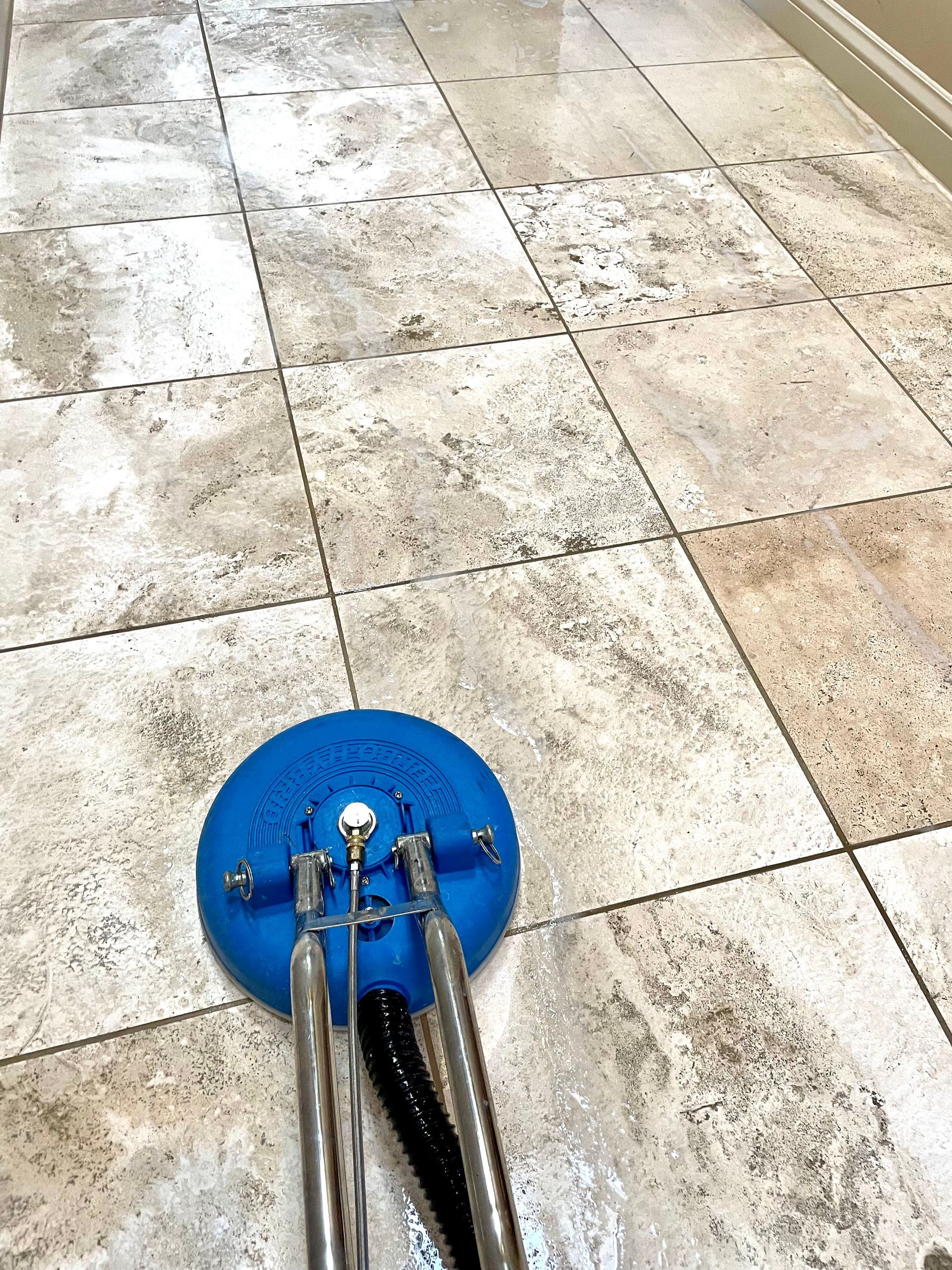 A person is polishing a granite floor with a machine.