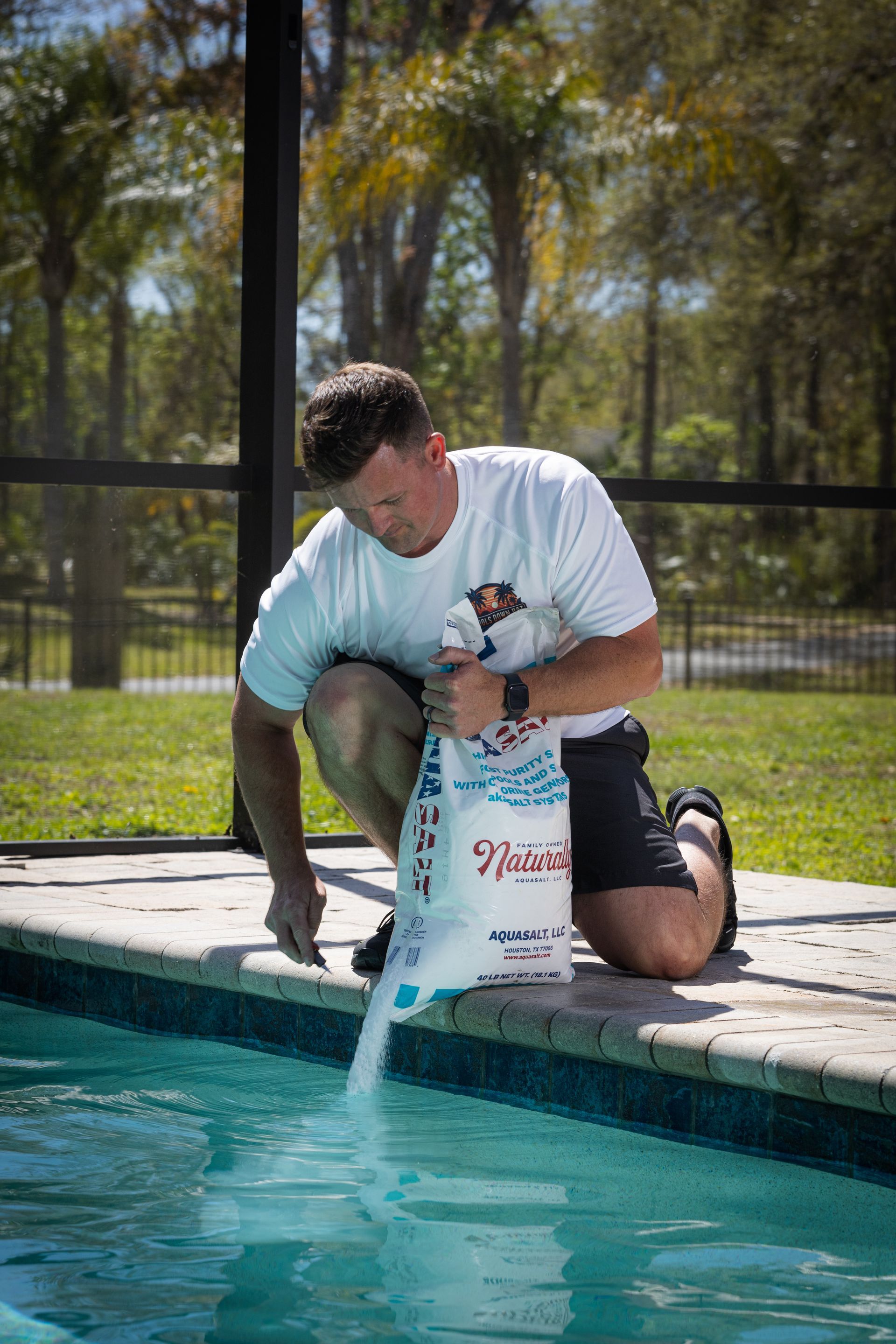 A cleaning kit is sitting next to a swimming pool.