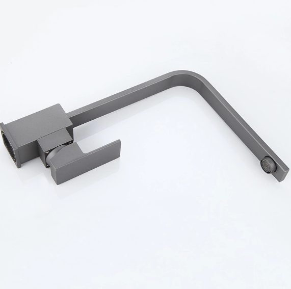 Grifo negro sobre un lavabo blanco en un baño moderno.