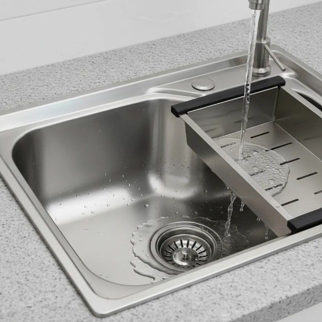 Fregadero de cocina de acero inoxidable con agua corriente y tendedero.