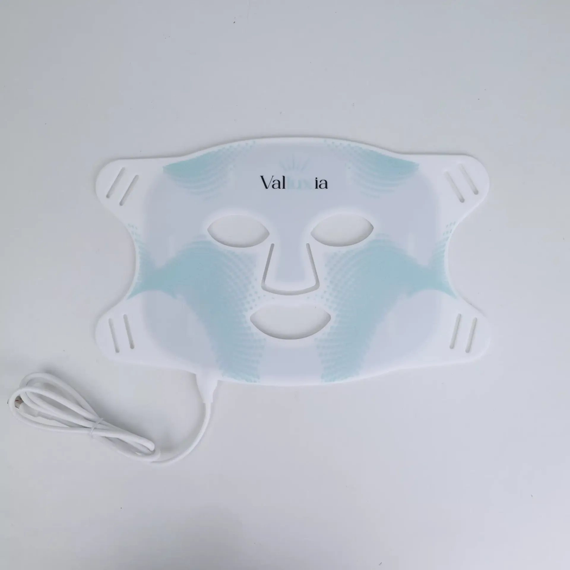 White LED face mask with eye, nose, and mouth cutouts, connected by a white cord.