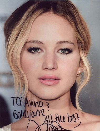 Close-up photo of Jennifer Lawrence with blonde hair and a signature. Text reads 