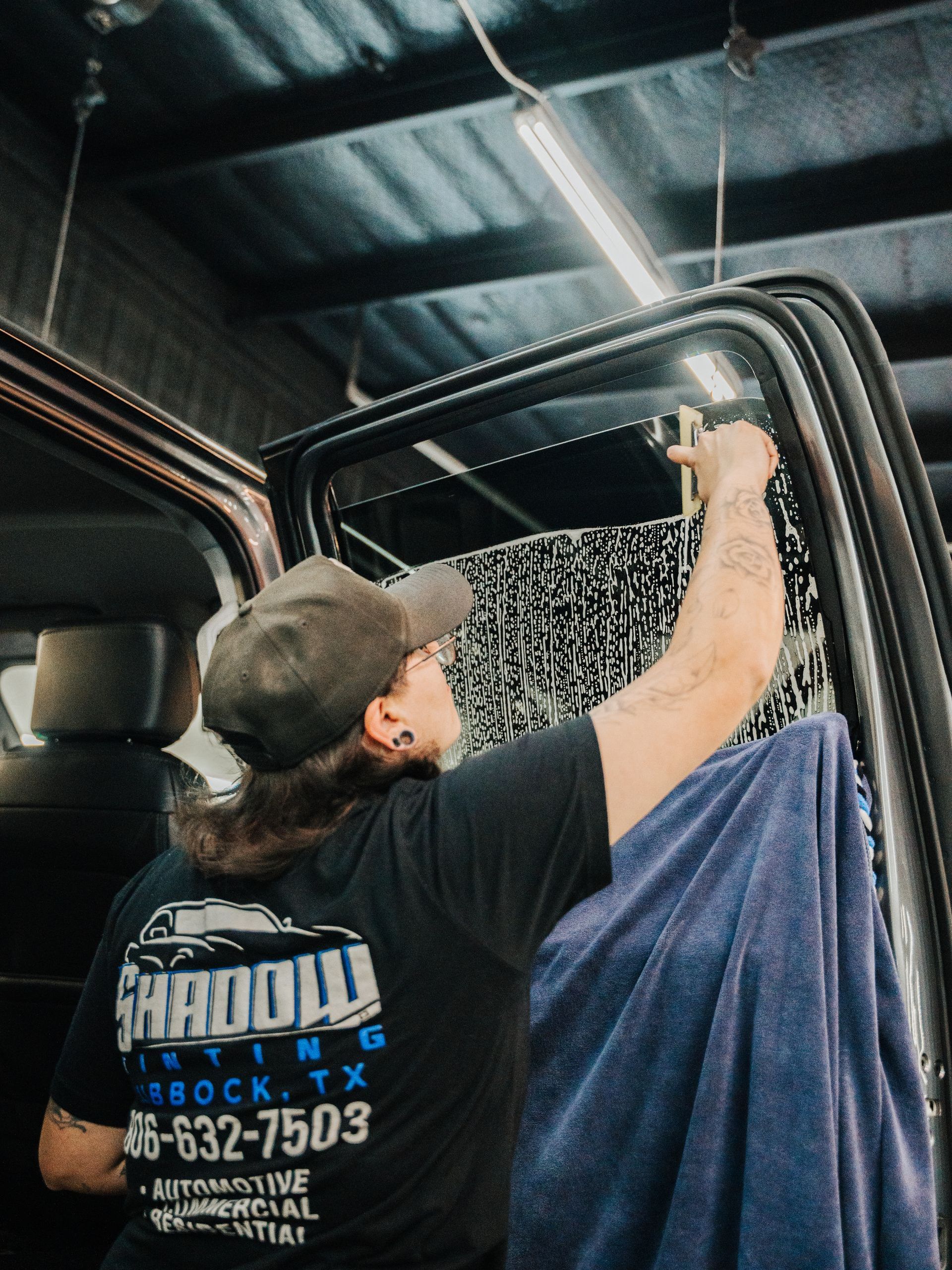 A man wearing a black shirt that says shadow on it