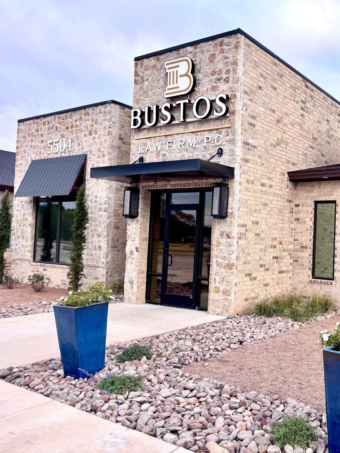 A brick building with a blue pot in front of it.