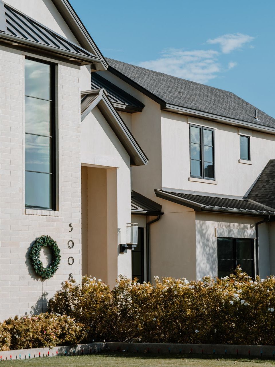 A white house with a wreath on the front door