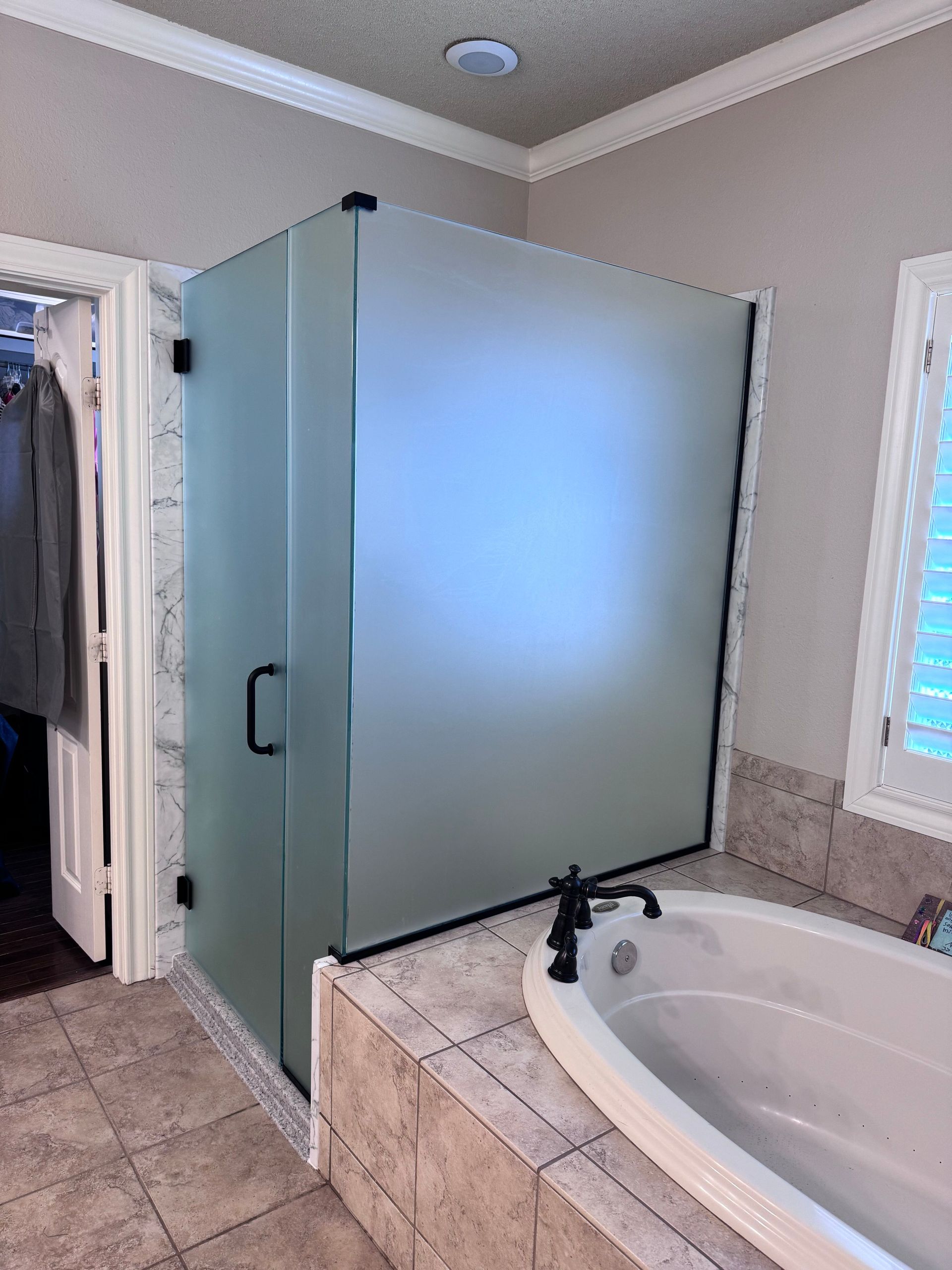 A bathroom with a bathtub and a shower stall.