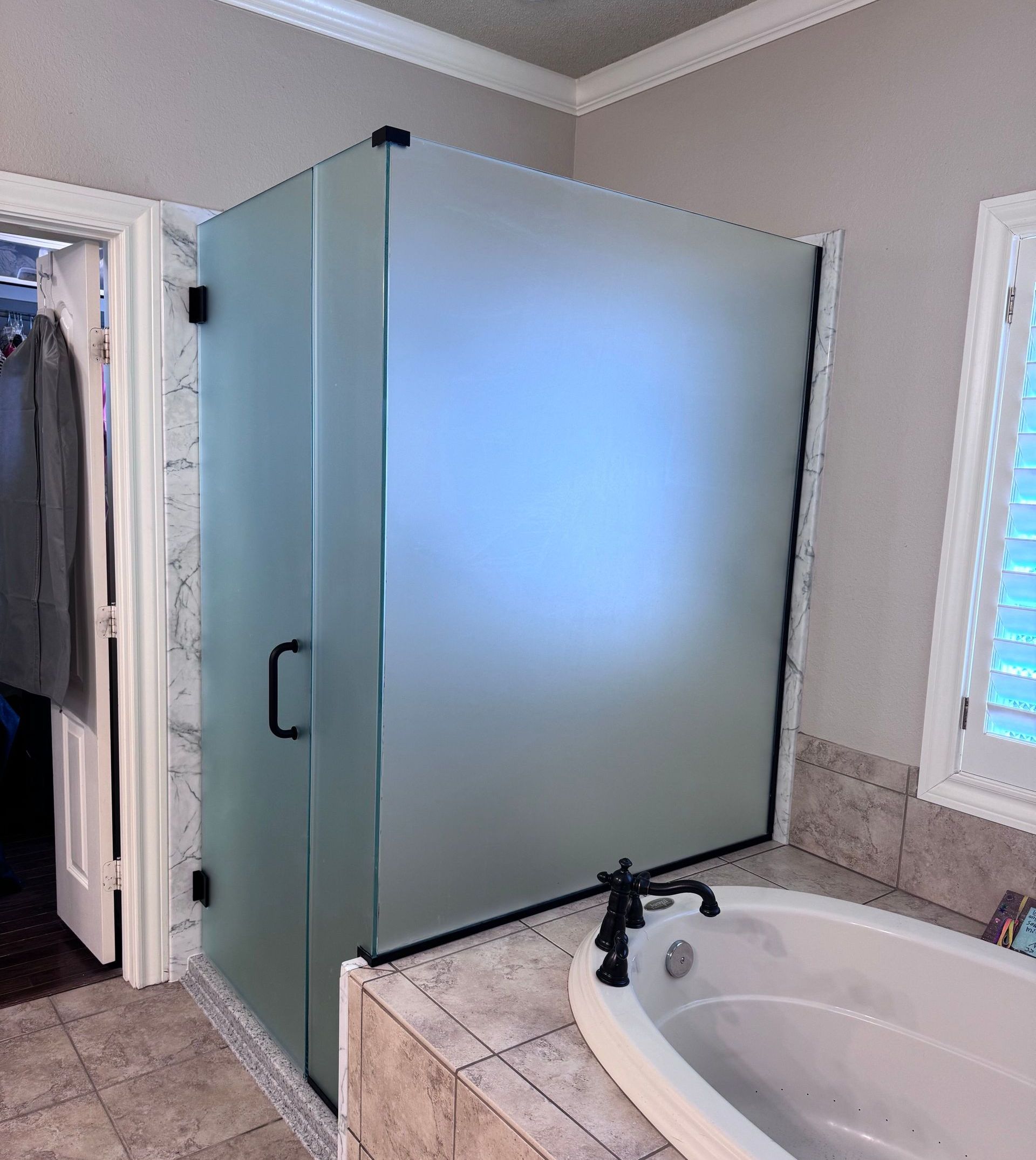 A bathroom with a bathtub and a shower stall