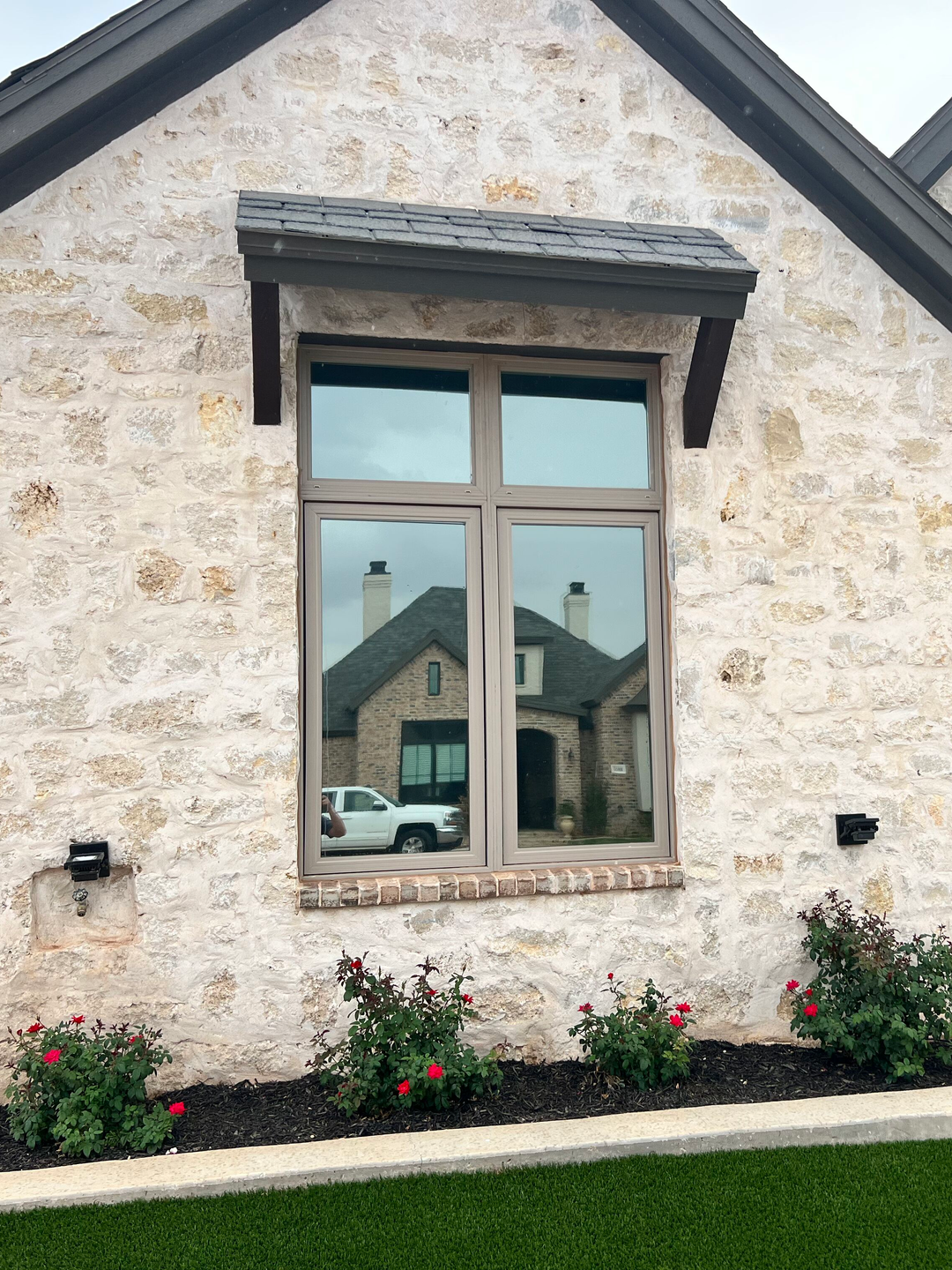 A house with a large window on the side of it.