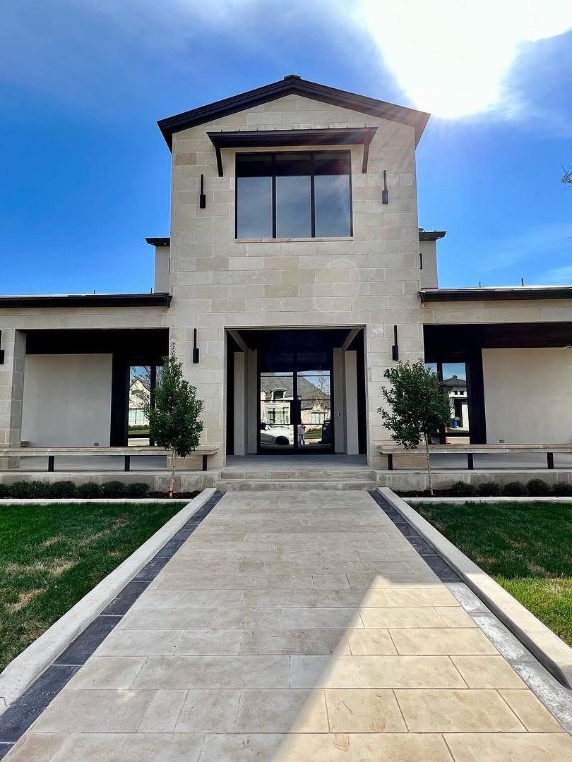 A large house with a walkway leading to it
