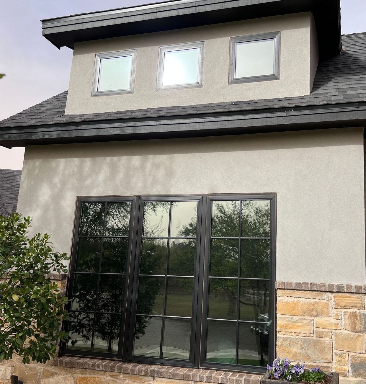 A house with a lot of windows and a roof