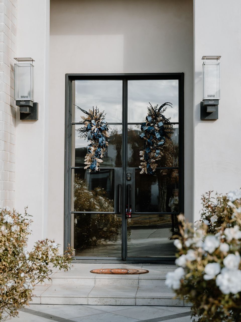 The front door of a house with a wreath on it.