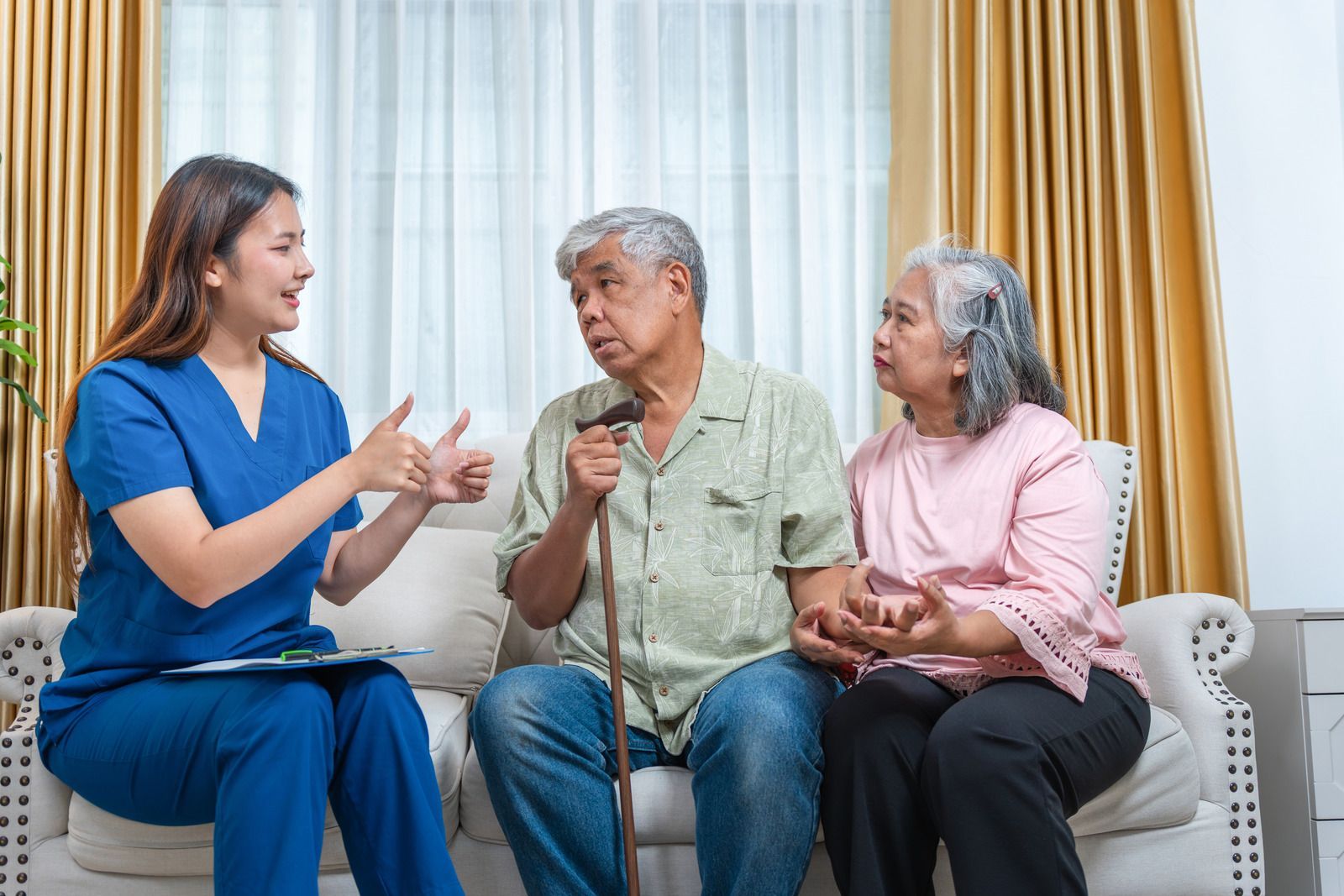 Three smiling women: a grandmother, mother, and daughter, close together, indoors.