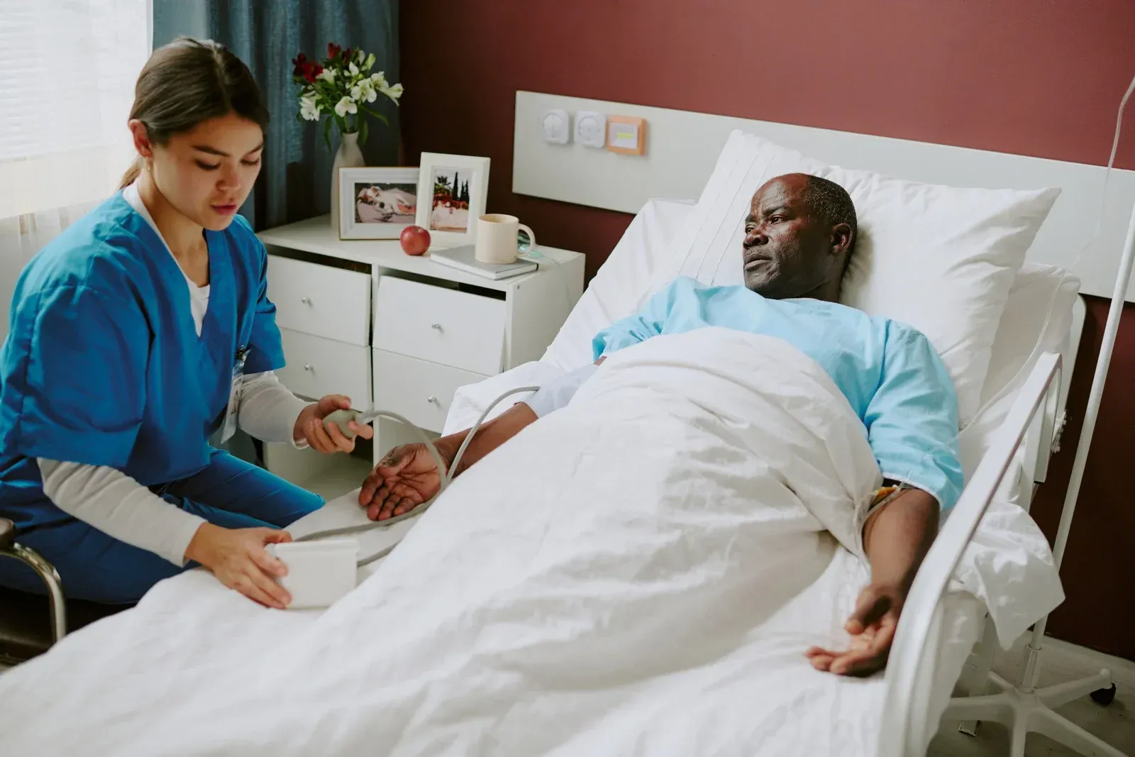 Three smiling women: a grandmother, mother, and daughter, close together, indoors.