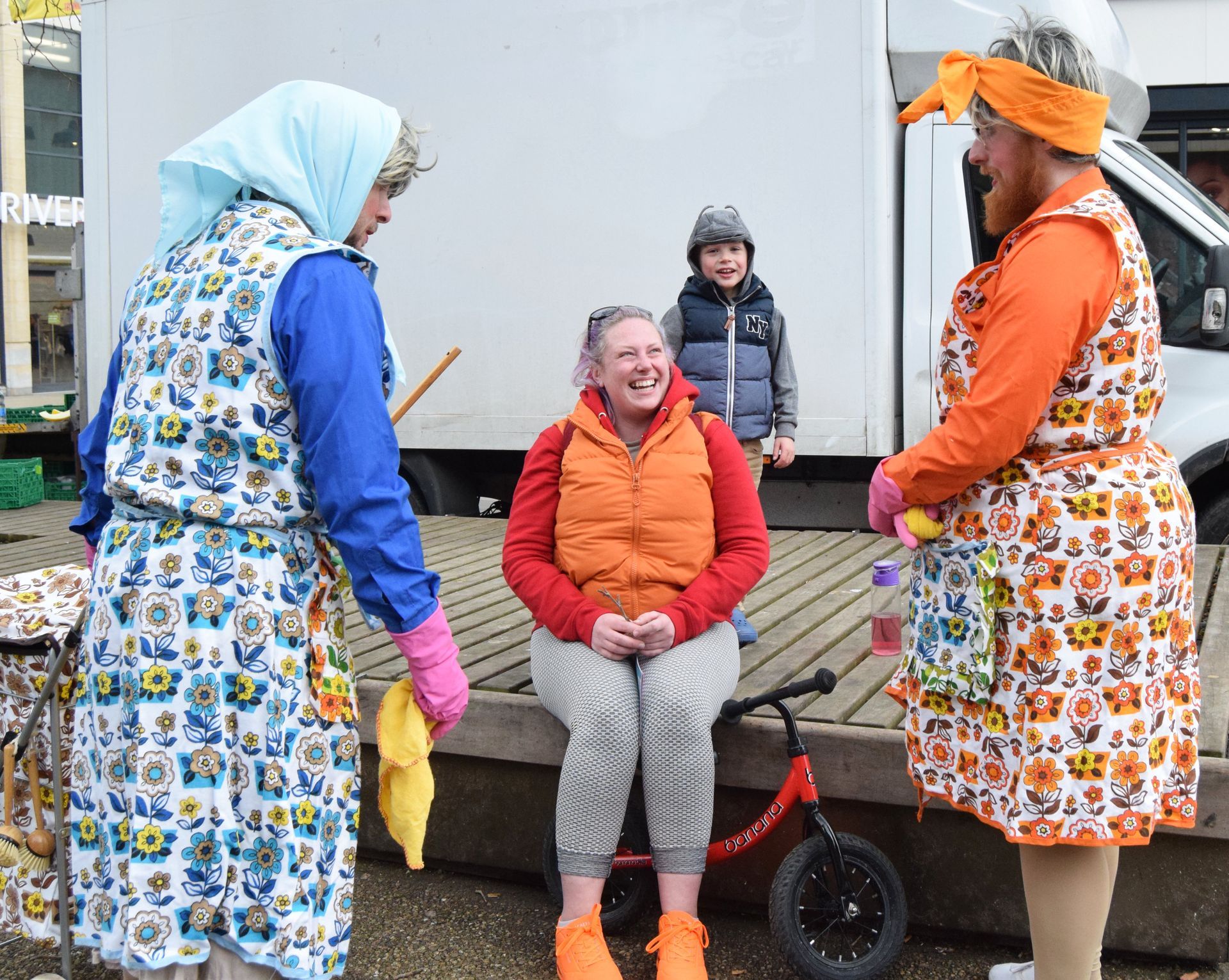 Mildred & Martha, The Dustbusters, making a mother and child laugh as they dust.