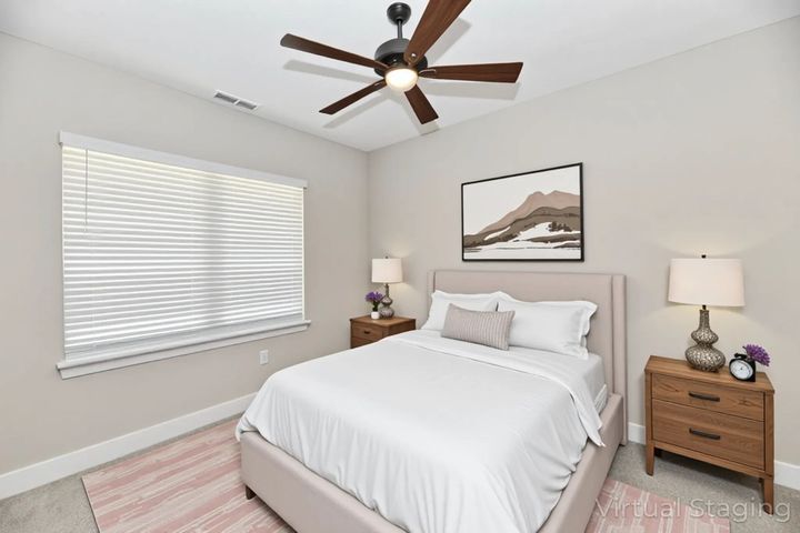 A living room with a couch , chair , and television.