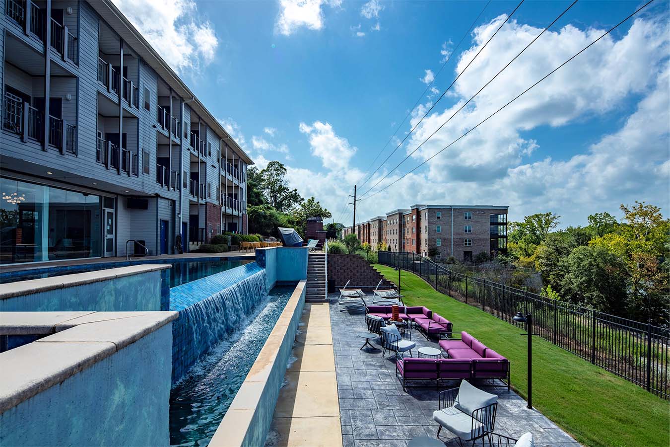 Exterior photo of an apartment building and pool