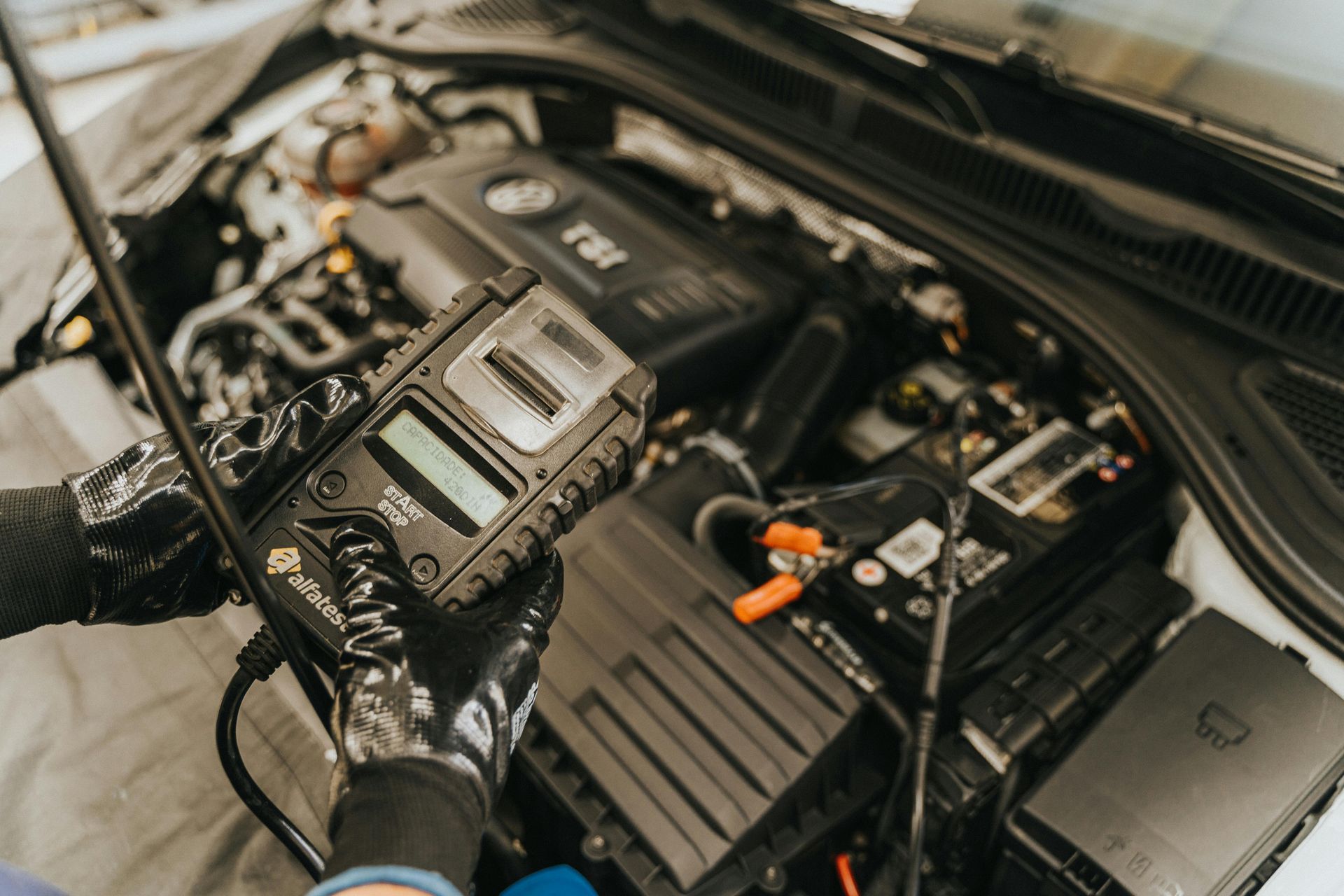 A person is working on the engine of a car.