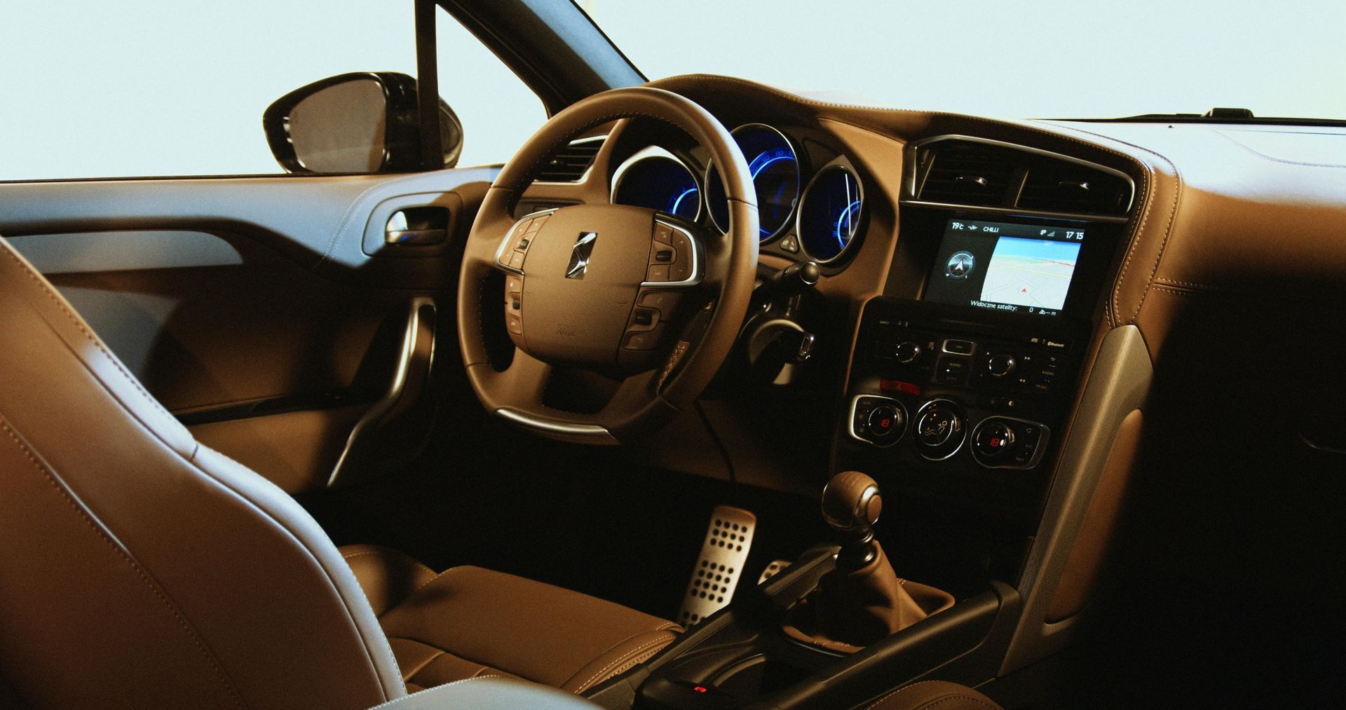 The interior of a car with a steering wheel that says peugeot on it