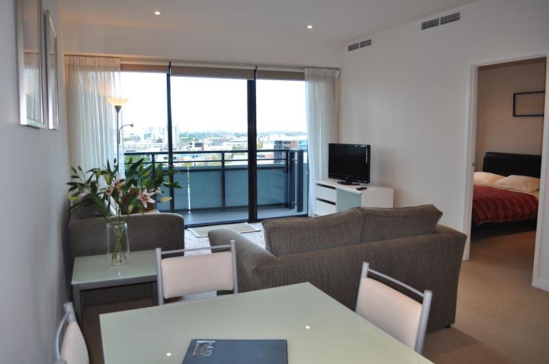 A living room with a table and chairs and a couch