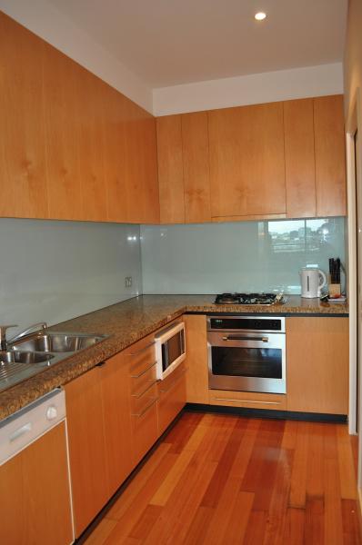 A kitchen with wooden cabinets and stainless steel appliances