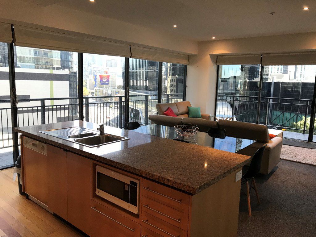 A living room with a large island in the middle and a couch.