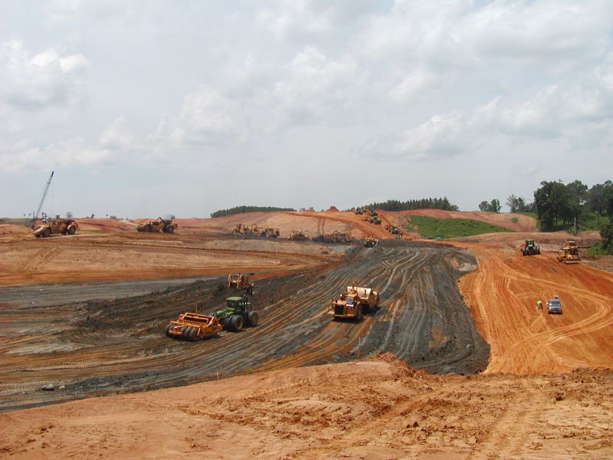 A construction site with a lot of trucks and tractors