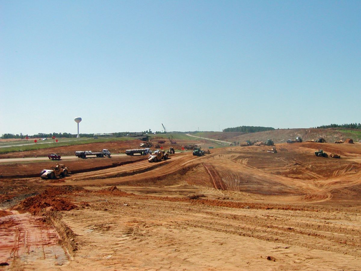 A construction site with a lot of dirt and trucks on it