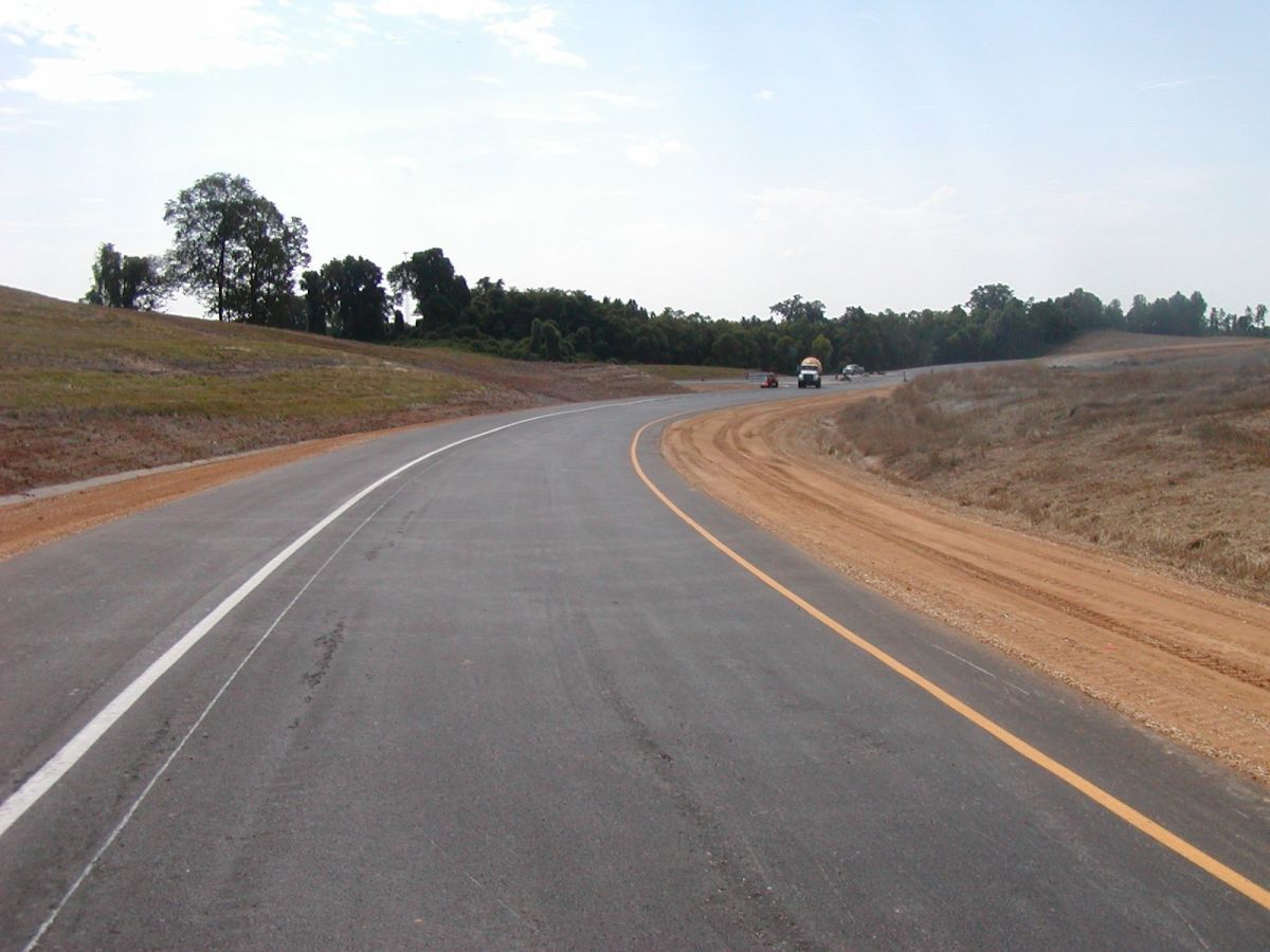 A curvy road with a white line on it