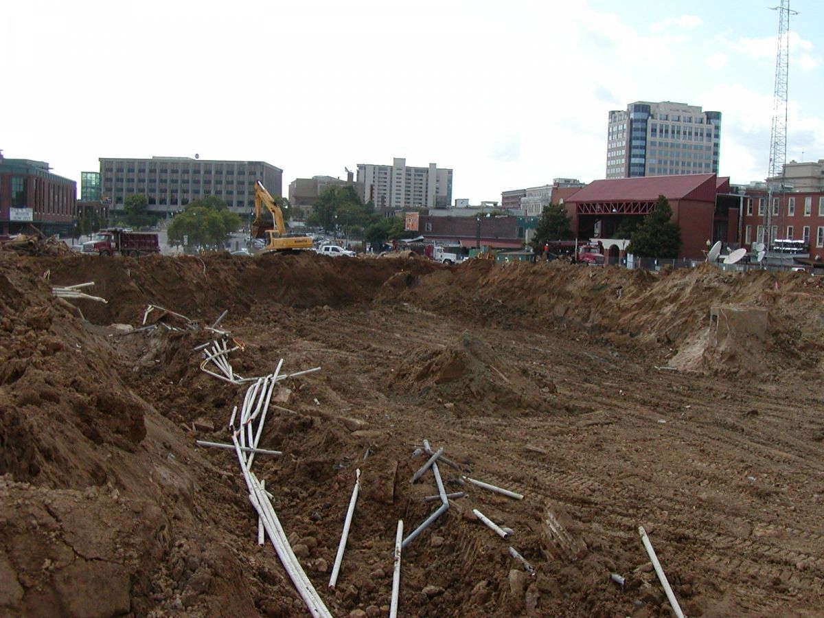 A construction site with a lot of dirt and pipes in it