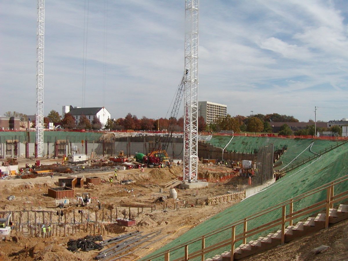 A construction site with a lot of cranes and stairs