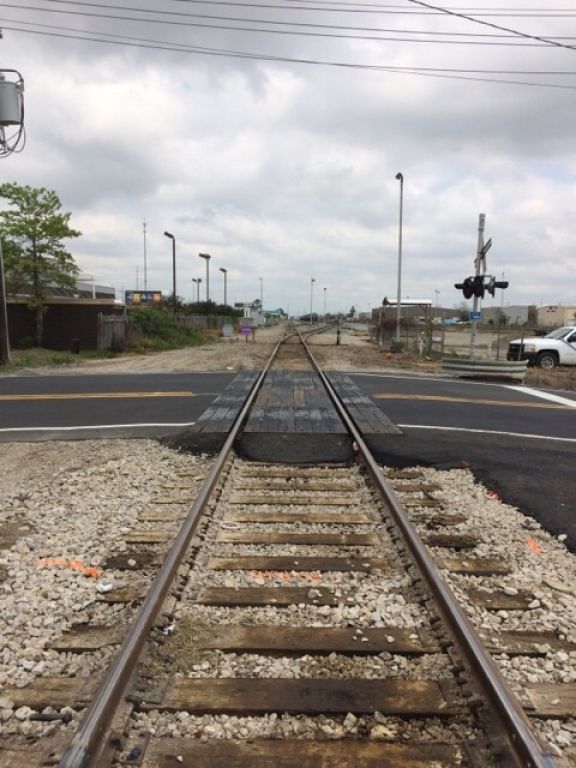 A train track that is going through a crossing