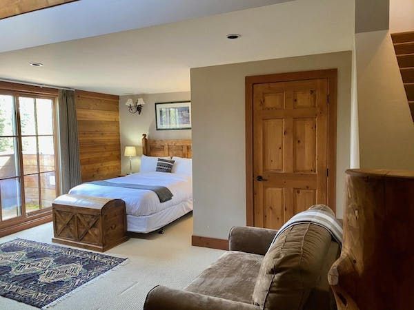 A bedroom with a bed , couch , and window.