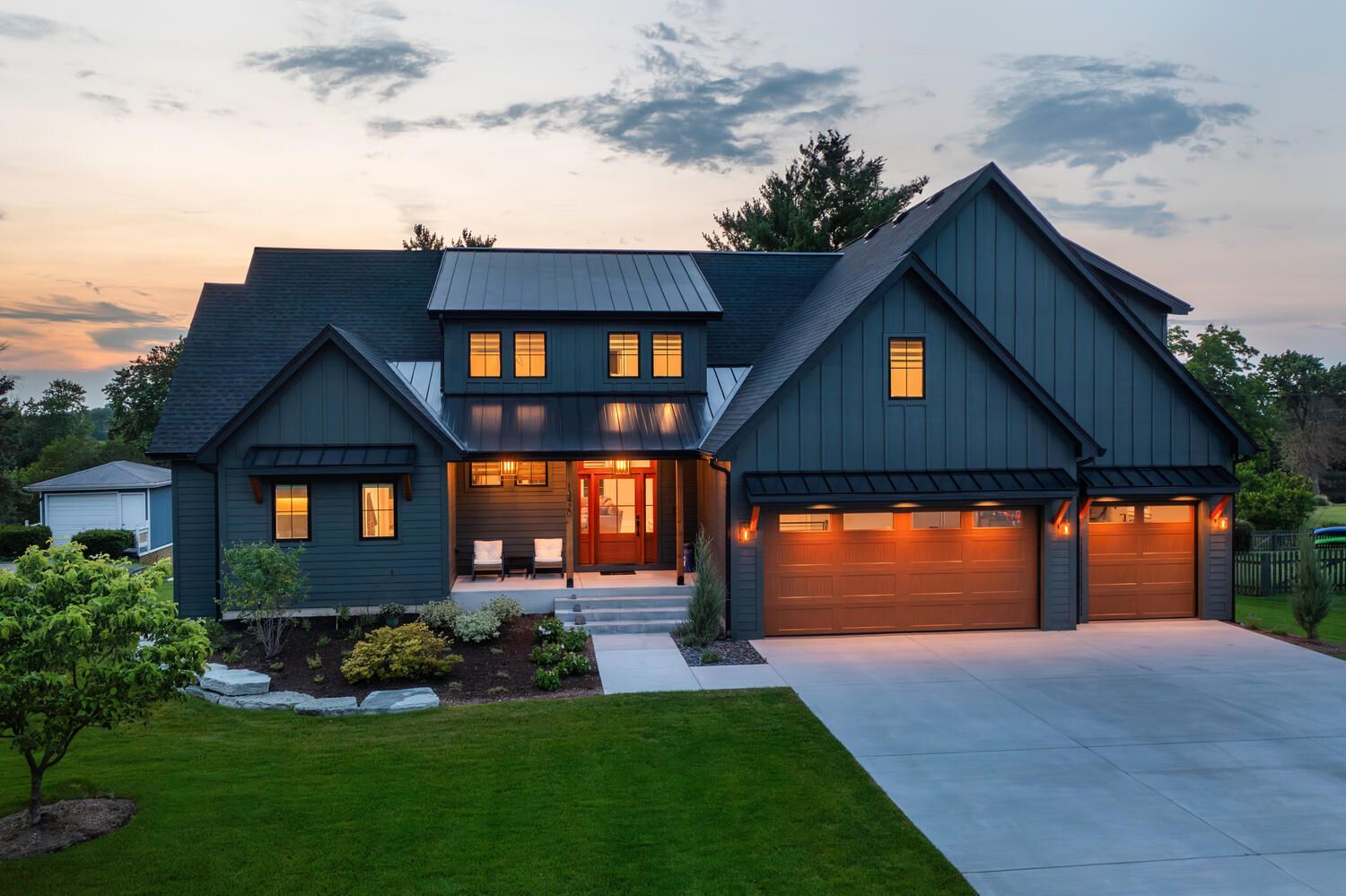 Custom home exterior three car garage.  Chicago western suburbs in Naperville, Hinsdale, Glen Ellyn, Highland Park.