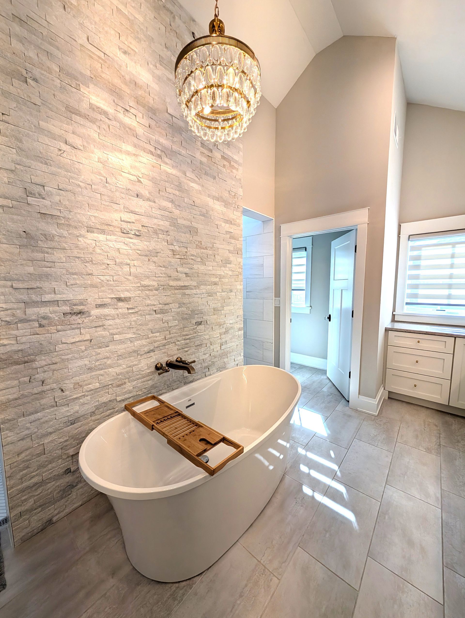 Custom home  bathroom with large soaker tub and light fixture in Elmhurst Illinois. Oak Brook, Highland Park, Lake Forest. 