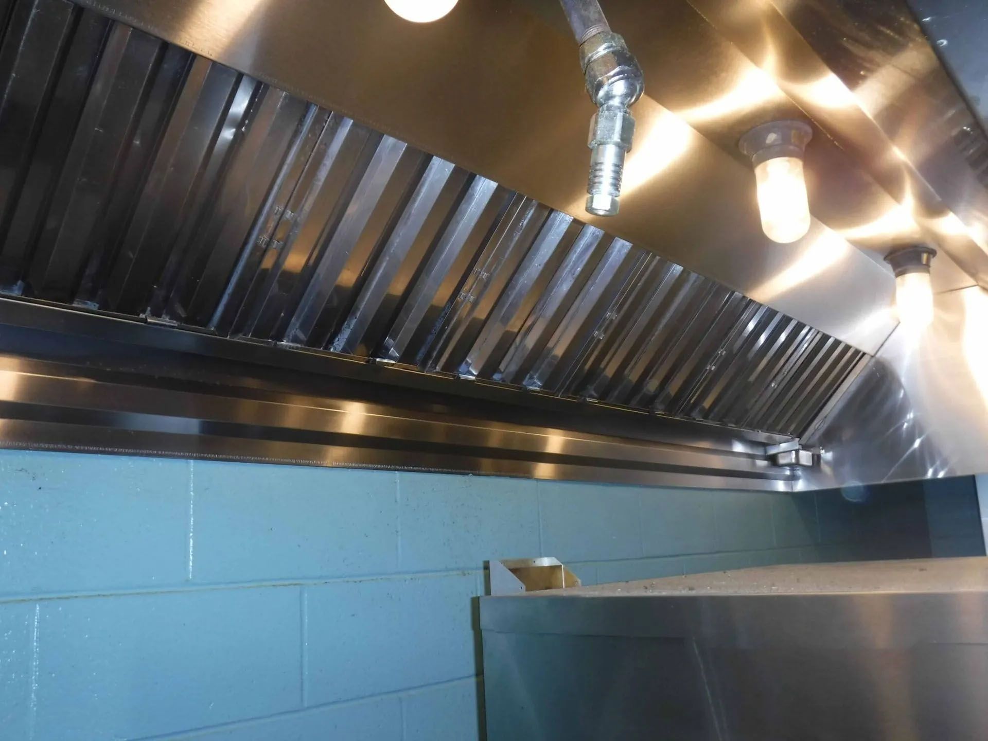 Stainless steel commercial kitchen exhaust hood.