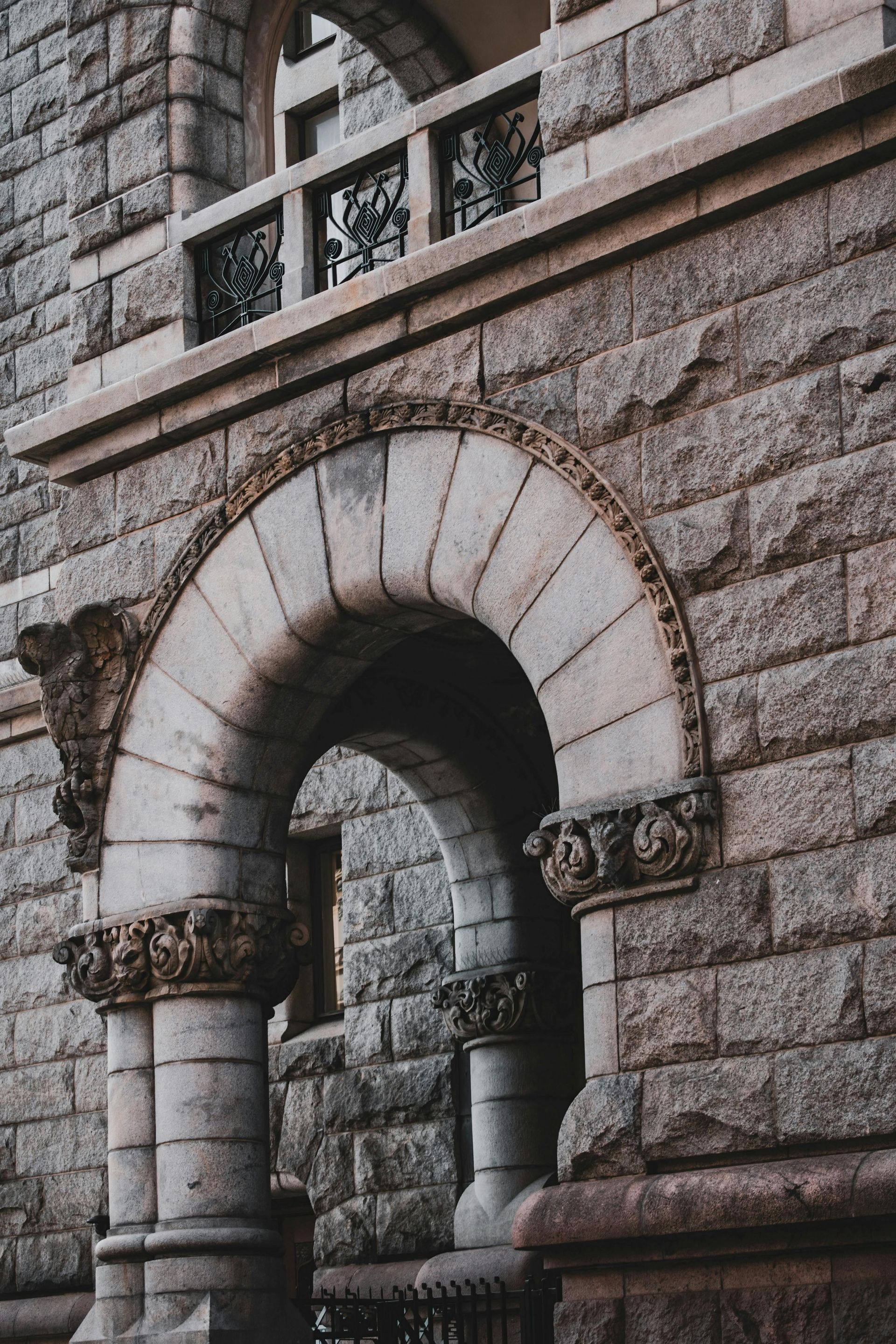 Stone archway on a building with decorative columns.