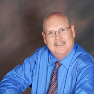 Three formally dressed people smiling indoors. A man on the left and right, woman in the middle.