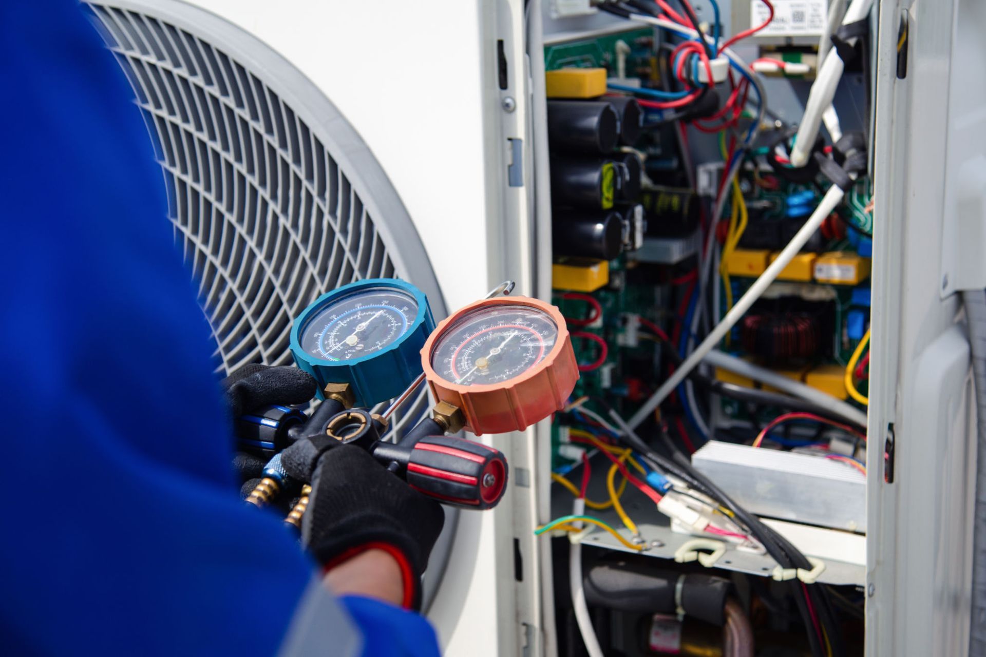 A professional technician working on a frontload washer during a repair session.