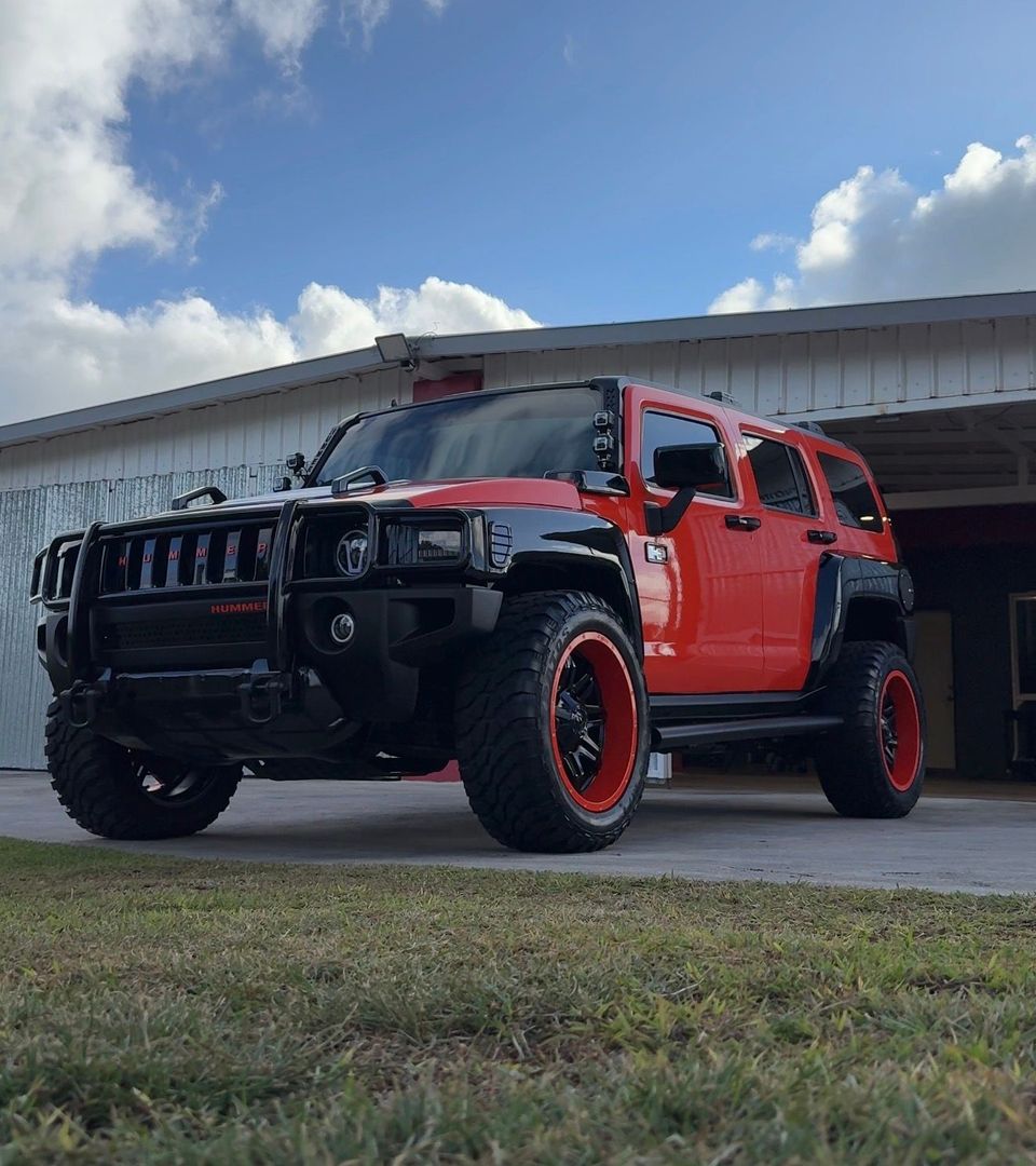 A red Toyota 4Runner SUV parked inside a garage with a 