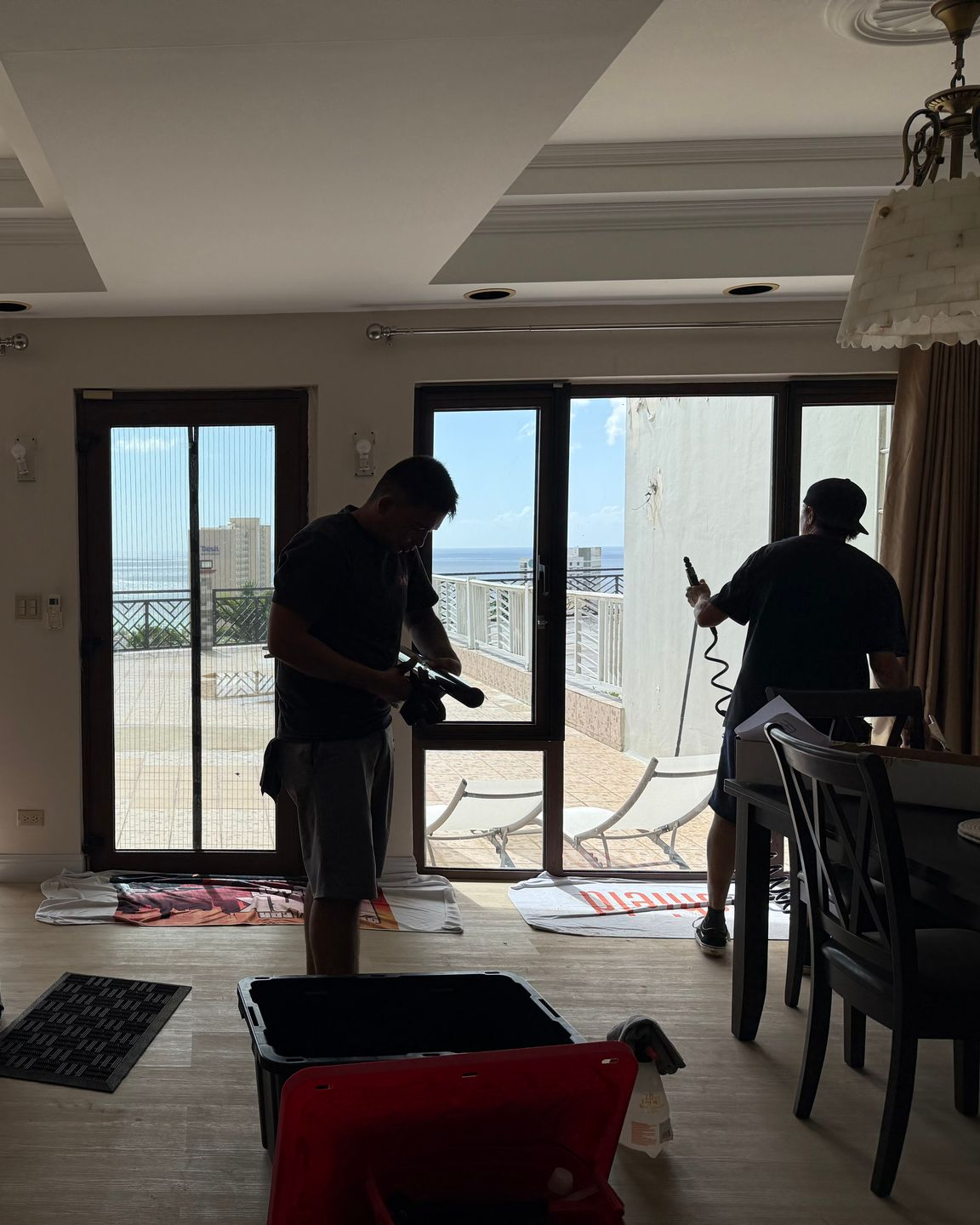 A person is cleaning a blue car with an orange towel
