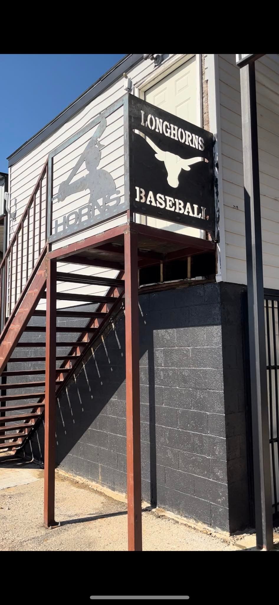 A building with stairs and a sign that says baseball on it.